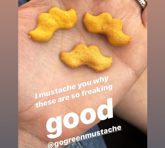 Crackers in customers hand.  Review reads I mustache you why these are so freaking good @gogreenmustache